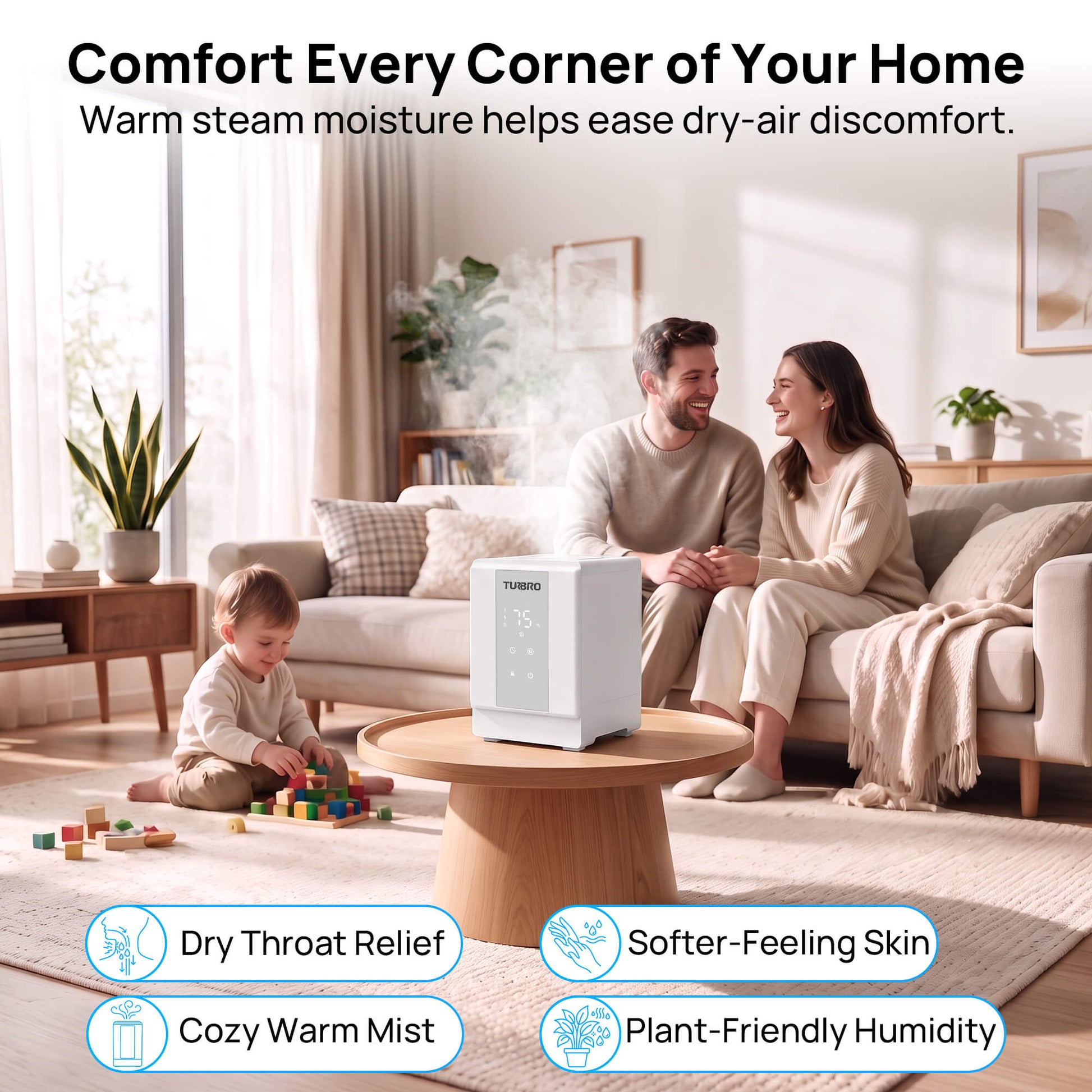 A white steam humidifier sits on a round wooden coffee table in a bright, modern living room. A man and woman are sitting on a sofa in the background, and a young child is playing with blocks on the floor.