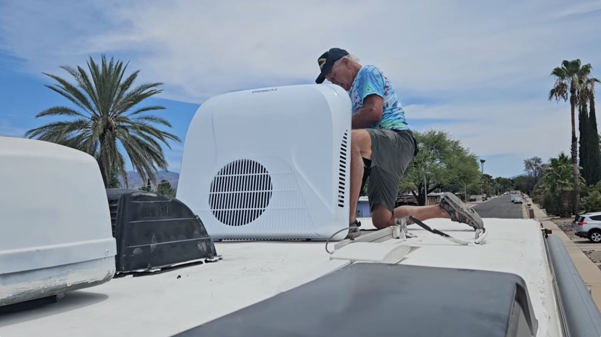 Dave on the roof of his RV installing a new TURBRO Greenland RV AC. 